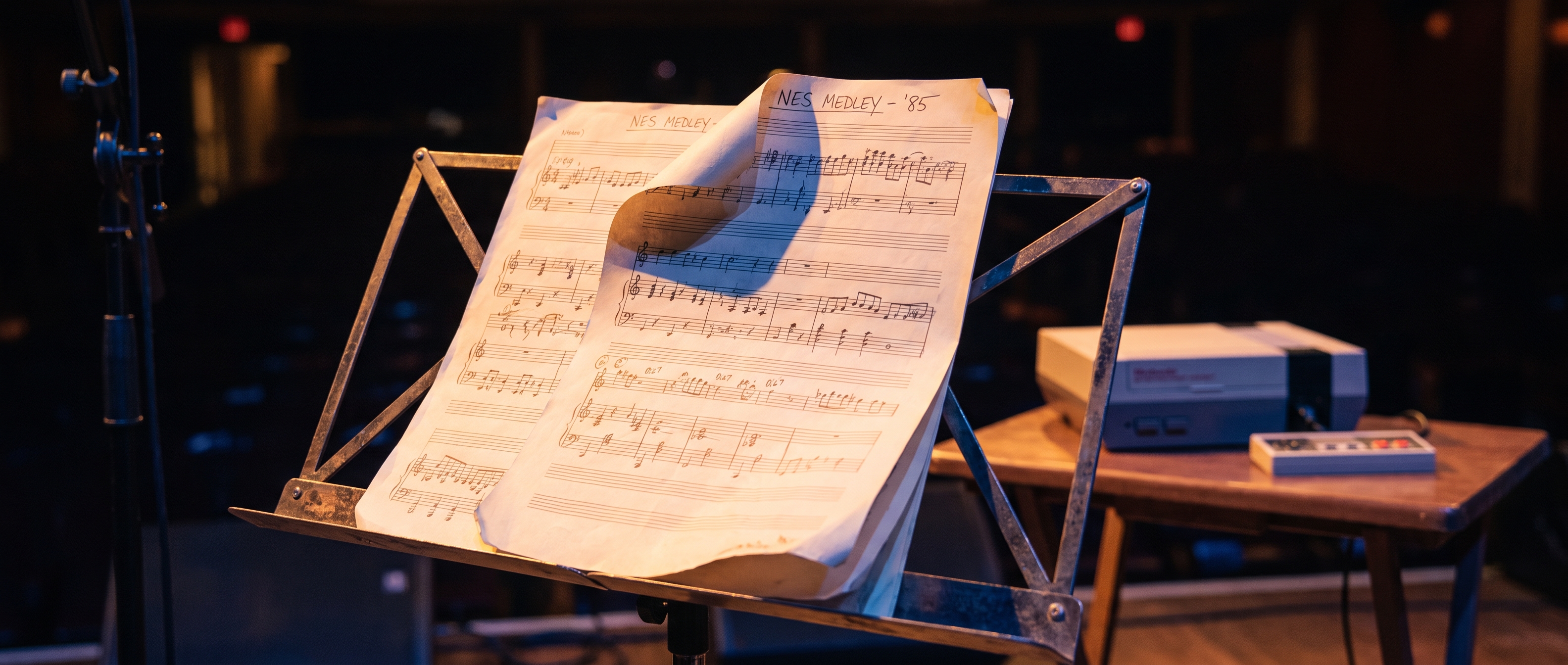 Sheet music on a music stand with NES console in background